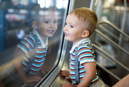 Young happy boy on train