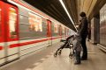 Family looking at train at subway station in Prague